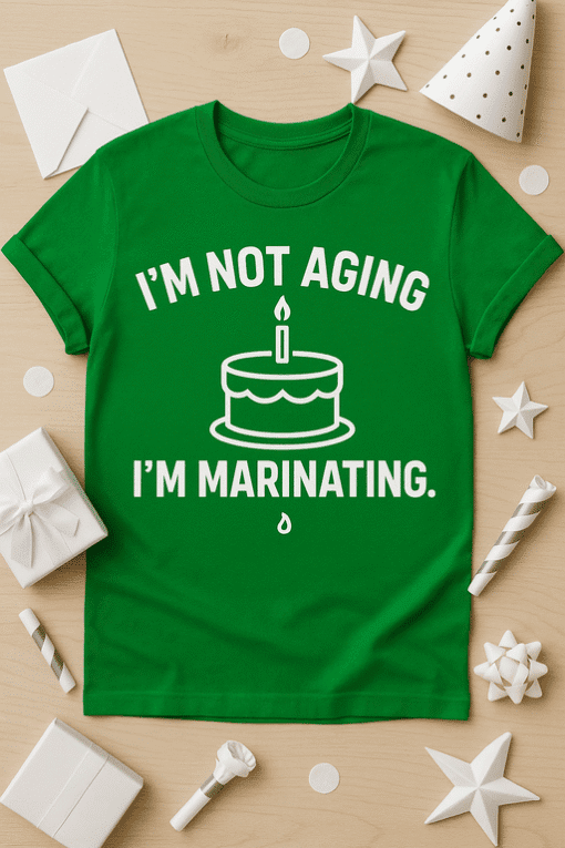 1. Funny birthday T-shirt with cake and candle design, perfect for marinating humor.