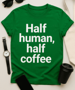Green T-shirt with humorous "Half human, half coffee" slogan for coffee lovers and casual wear.