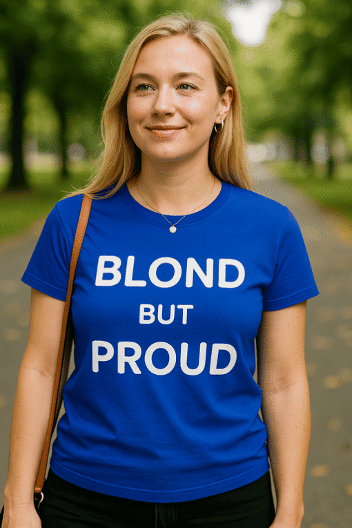 Blonde woman wearing blue "Blond but Proud" t-shirt outdoors.