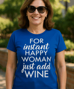 Happy woman wearing fun wine quote T-shirt, cheerful outdoor park scene, trendy casual summer tee, stylish women’s graphic shirt, perfect gift idea.