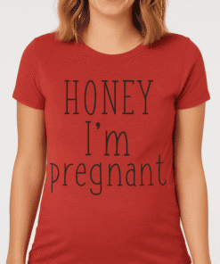 Pregnant woman wearing humorous "Honey I'm pregnant" T-shirt, perfect for maternity and pregnancy announcement.