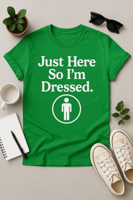 Green graphic tee shirt with humorous "Just Here So I’m Dressed." quote and person icon for casual fashion.