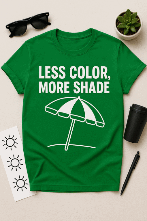 Bright green T-shirt with "Less Color, More Shade" slogan and umbrella graphic for casual sunny day wear.