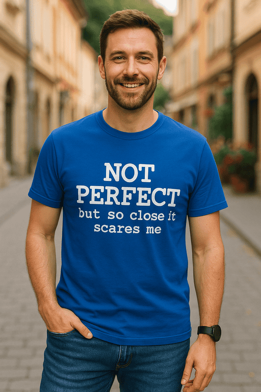 1. Smiling man wearing blue T-shirt with humorous quote, outdoor urban background.