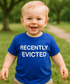 1. Child wearing blue T-shirt with "Recently Evicted" text in park setting.