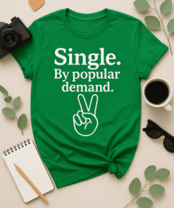 Cute green T-shirt with "Single. By popular demand" quote and peace hand graphic, perfect for casual wear and single life humor.