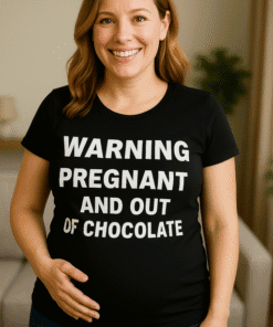 Pregnant woman wearing humorous black T-shirt with warning message about pregnancy and chocolate.