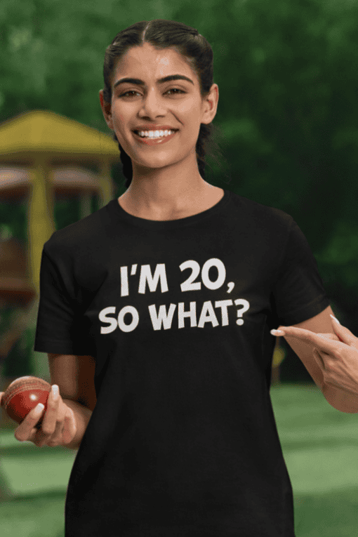 1. Smiling woman wearing "I'M 20, SO WHAT?" funny t-shirt outdoors.