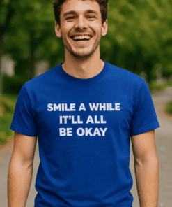 Happy man smiling wearing blue T-shirt with inspirational quote outdoors.
