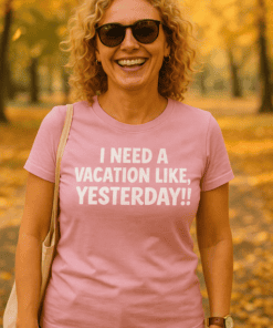 Relaxed woman wearing pink T-shirt with vacation quote in a park during autumn.
