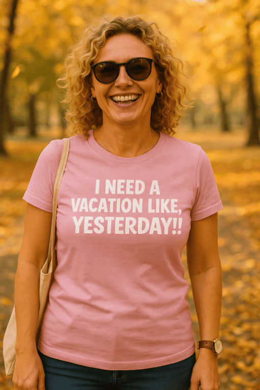 Relaxed woman wearing pink T-shirt with vacation quote in a park during autumn.