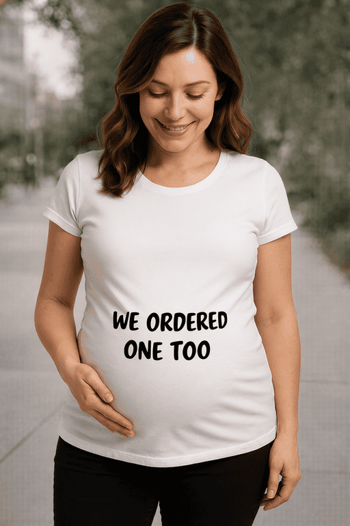 "Pregnant woman wearing funny maternity t-shirt, We Ordered One Too, at park".