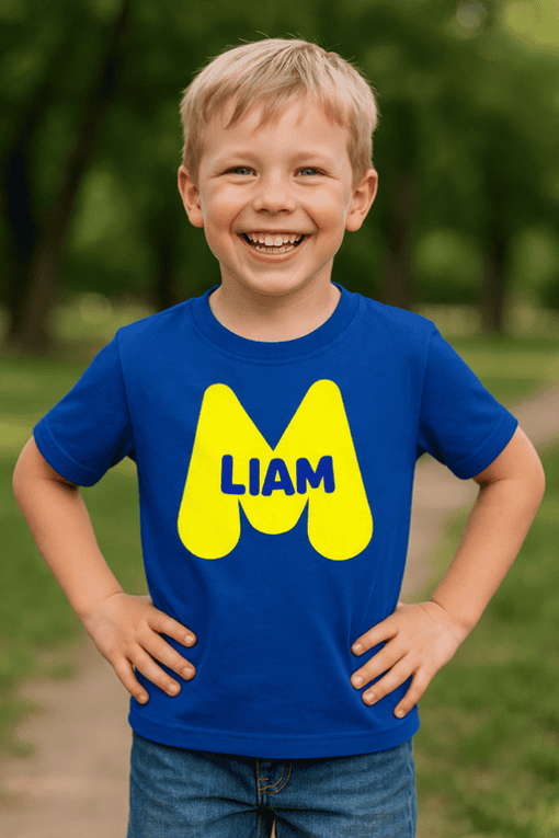 Bright blue kids' T-shirt with personalized "LIAM" and playful yellow letter M design, perfect for kids' sizes.