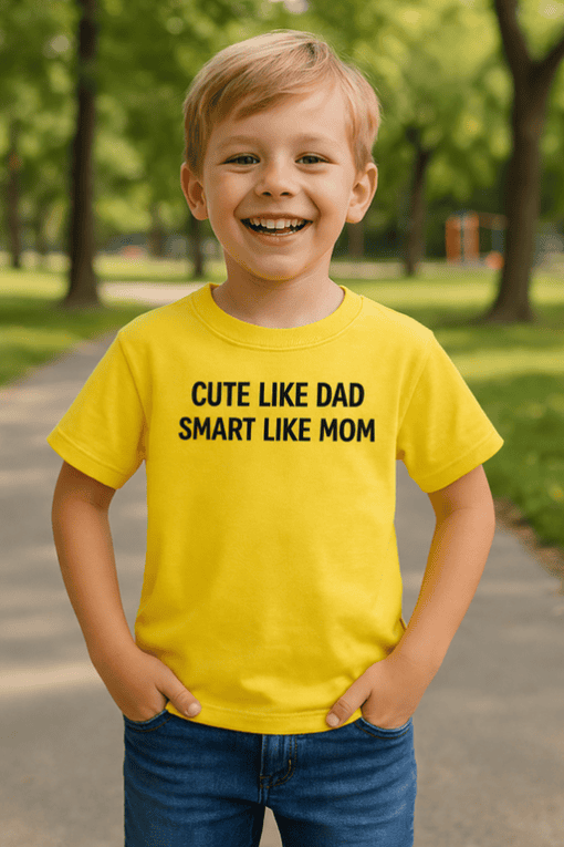 Bright yellow kids' T-shirt with humorous "Cute Like Dad, Smart Like Mom" slogan for casual wear and fun family matching outfits.