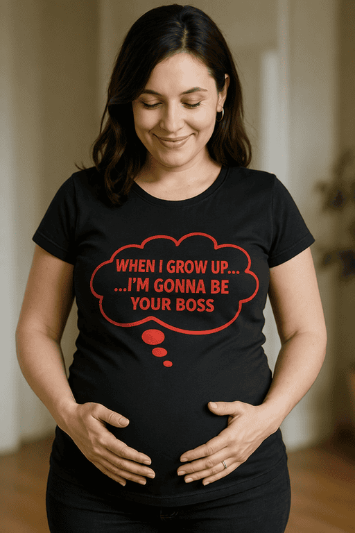 - Pregnant woman wearing humorous black T-shirt with red text saying "When I grow up... I'm gonna be your boss".