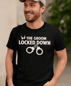 Handsome man wearing humorous wedding-themed T-shirt with handcuff graphic and playful message.