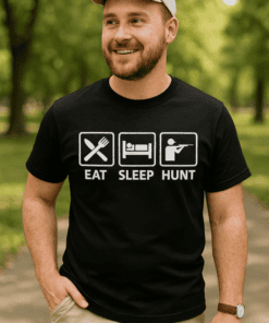 Man wearing casual T-shirt with "Eat Sleep Hunt" icons outdoors, smiling and enjoying nature.