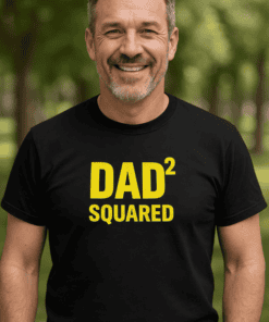 1. Smiling man wearing black "DAD² SQUARED" t-shirt outdoors.