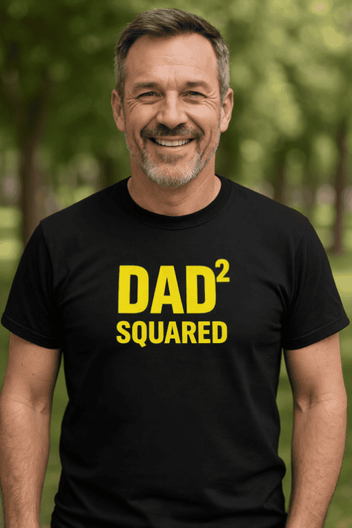 1. Smiling man wearing black "DAD² SQUARED" t-shirt outdoors.