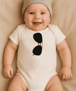 1. Baby wearing white onesie with black sunglasses graphic, adorable infant style.