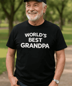 Happy Grandpa wearing a "World's Best Grandpa" T-shirt outdoors, celebrating family and special moments.