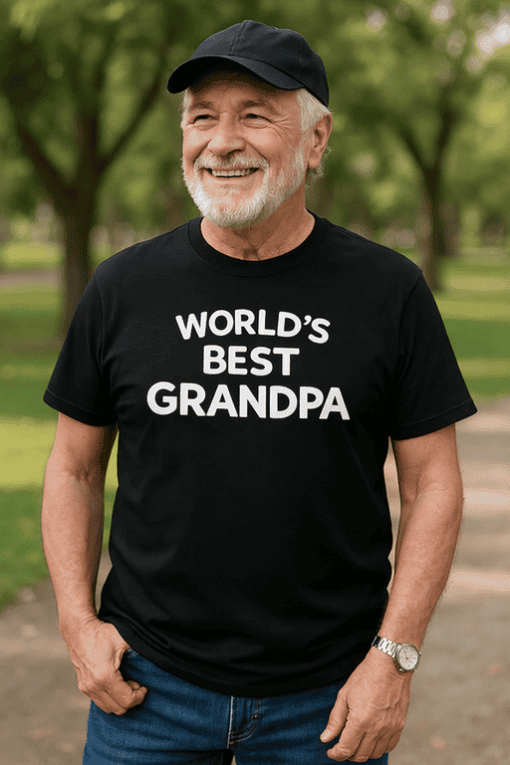 Happy Grandpa wearing a "World's Best Grandpa" T-shirt outdoors, celebrating family and special moments.