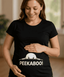 Cute pregnant woman wearing a black T-shirt with "PEEKABOO!" graphic and ghost design, celebrating pregnancy.
