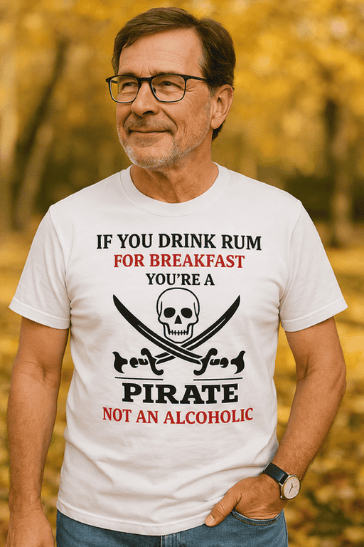 A man wearing a humorous pirate-themed T-shirt with skull and crossbones graphic, outdoors in fall.