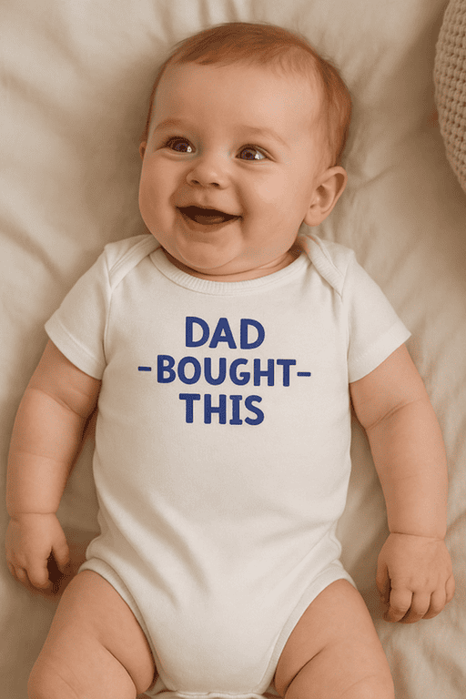 Cute baby wearing a "Dad-Bought-This" on a white onesie, perfect for humorous gift ideas.