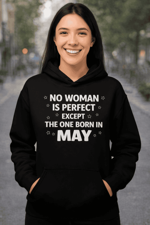 Bright woman smiling in black hoodie with May birthday quote, outdoor urban background, trendy women's fashion.