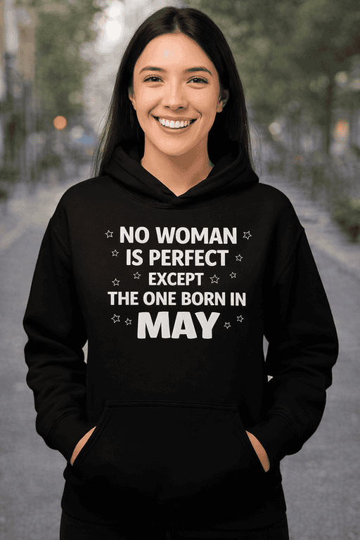Bright woman smiling in black hoodie with May birthday quote, outdoor urban background, trendy women's fashion.