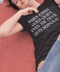 Happy woman lying on ground in black quote t-shirt about Emma and nervousness, casual fashion, relatable quote, trendy tee, comfortable clothing.