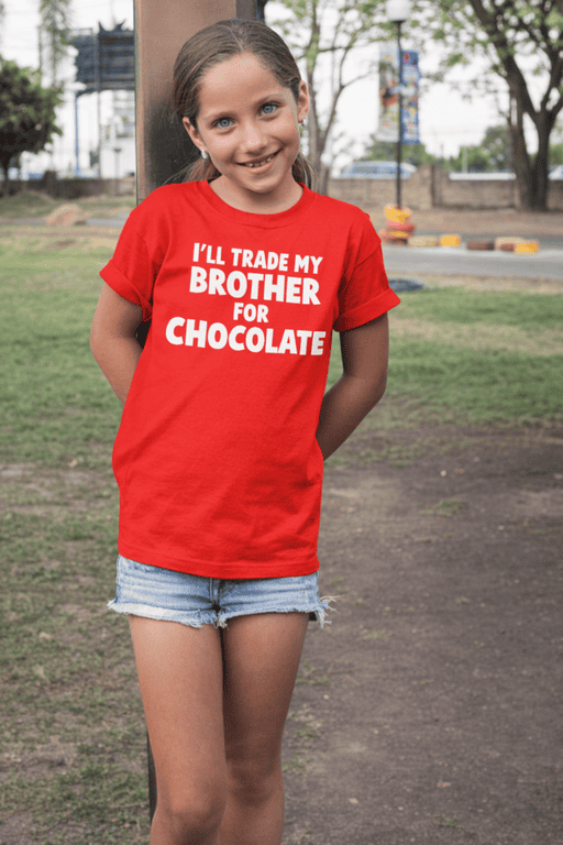 Cute girl wearing a red T-shirt with humorous chocolate trade quote for kids and family apparel SEO.