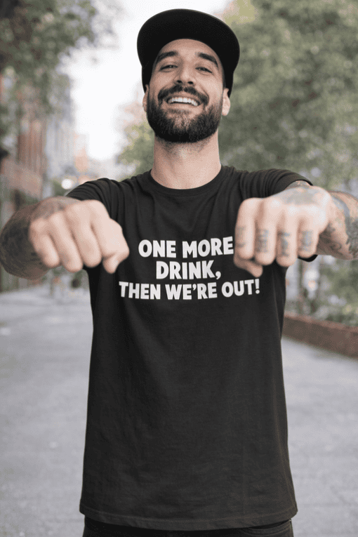 Funny black t-shirt with slogan for men and women lounging outdoors.