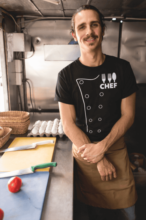 Chef t-shirt with kitchen utensil design, perfect for cooking enthusiasts and culinary professionals.