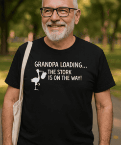 Smiling man wearing humorous Grandpa T-shirt outdoors, perfect for funny family shirts.