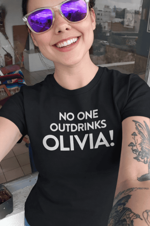 1. Custom T-shirt with "No One Outdrinks Olivia!" message for personalized drink awareness.