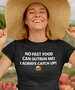 1. Women wearing black T-shirt with humorous fast food quote and oversized hat outdoors.