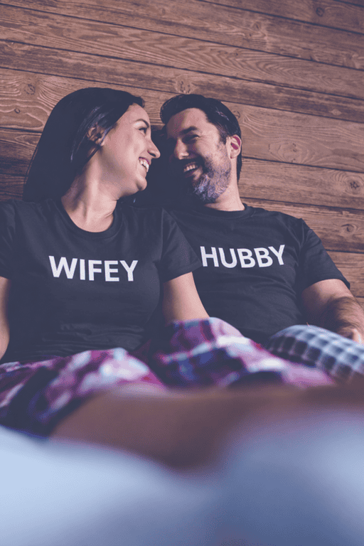 Happy couple wearing "WIFey" and "HUBBY" matching T-shirts, couple relationship humor, couple tees, love and friendship shirts.