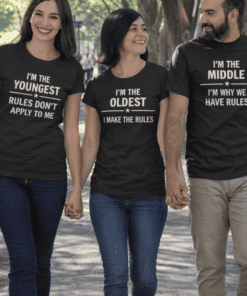 1. Smiling people wearing matching black funny quote t-shirts in park.