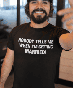 1. Smiling man wearing black T-shirt with humorous "Nobody Tells Me When I’m Getting Married" quote.