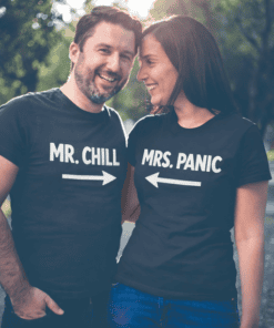 Happy couple wearing matching Mr. Chill and Mrs. Panic funny couple T-shirts outdoors.