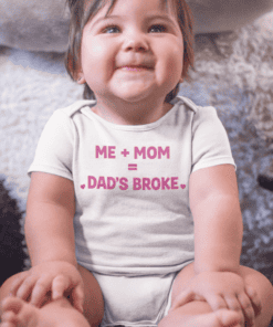 Cheerful toddler girl wearing a cute T-shirt with fun dad joke phrase "Me + Mom = Dad's Broken".