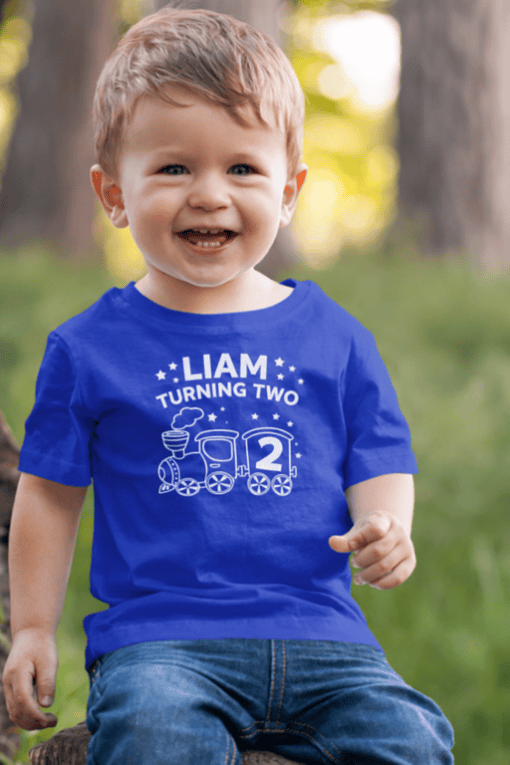 Happy birthday boy in personalized Liam turning two T-shirt, kids birthday celebration, fun toddler birthday outfit.