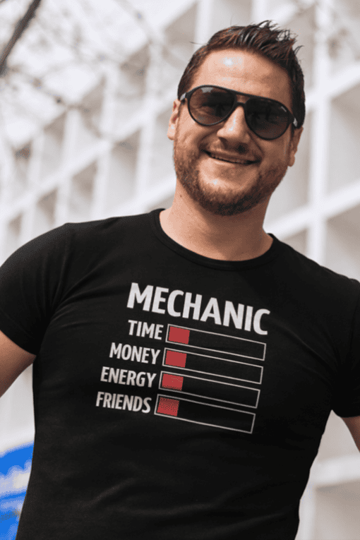 1. Man wearing black mechanic-themed T-shirt with humorous design and sunglasses.