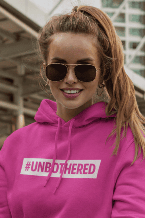#1. Stylish pink hoodie with "#UNBOTHERED" slogan for women’s fashion and casual wear.