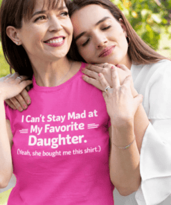 Mom and daughter embracing, wearing funny matching t-shirts, celebrating family bond.