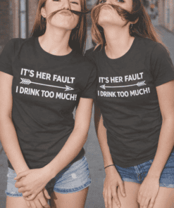 Funny women's T-shirt with "It's her fault I drink too much" phrase, casual quote tee, humorous graphic tee, matching best friend T-shirts, playful matching T-shirt style.