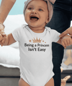 Cute baby girl wearing a princess-themed onesie with the text "Being a Princess Isn’t Easy.".