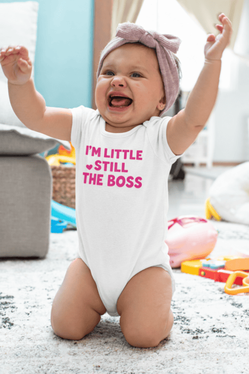1. Baby onesie with "I'm little, still the boss" text, newborn clothing, cute toddler apparel.